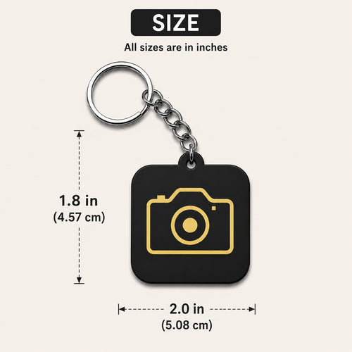 Black acrylic camera keychain with gold camera icon measuring 1.8 inch height and 2 inch width