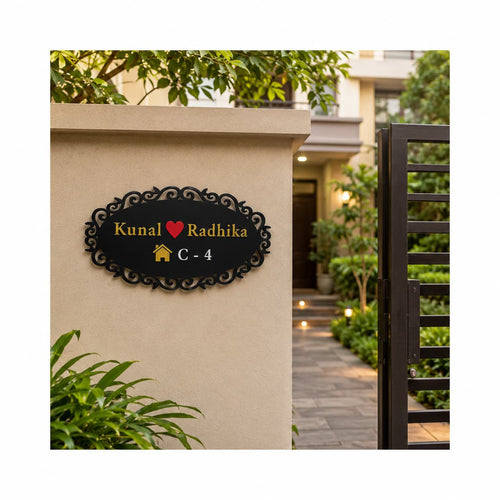 Black acrylic couple name plate with golden mirror names red heart and white house number mounted at apartment entrance wall by 11gifts