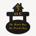 Custom doctor house name plate with black acrylic base and gold mirror acrylic raised lettering on clean background