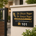 Black acrylic name plate with golden mirror 3D letters for Dr Divya Nagar and Dr Somya Nagar installed at a villa entrance