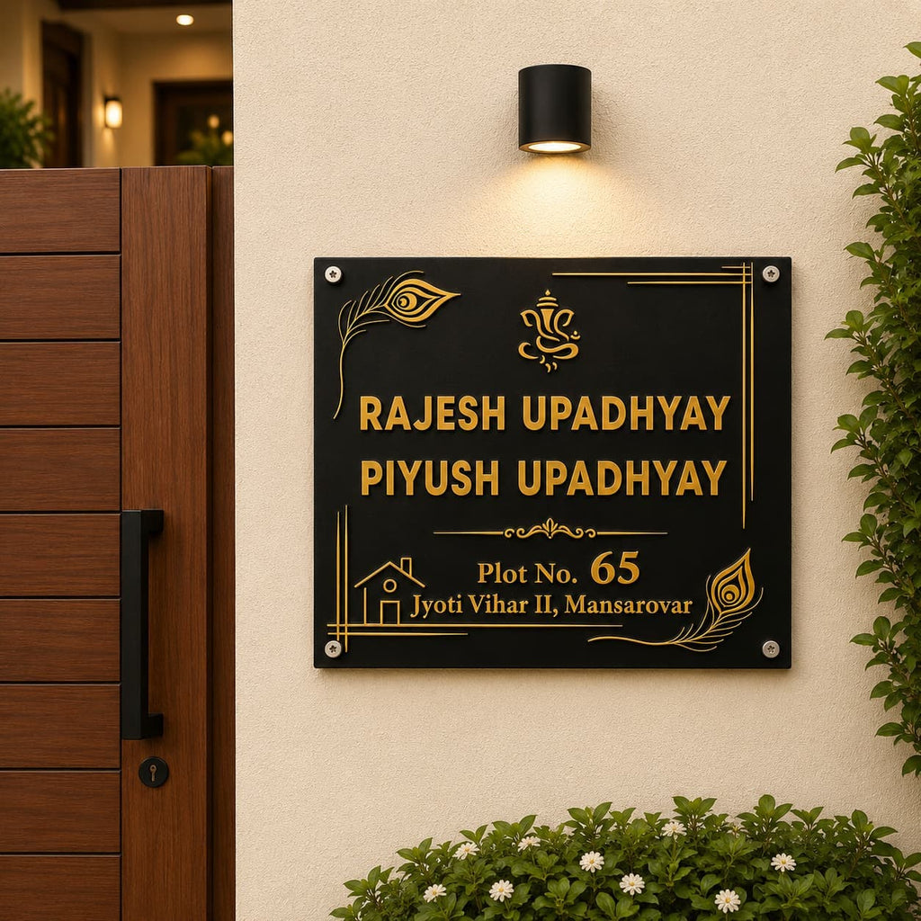 Black acrylic debossed family name plate with gold mirror backing on entrance wall