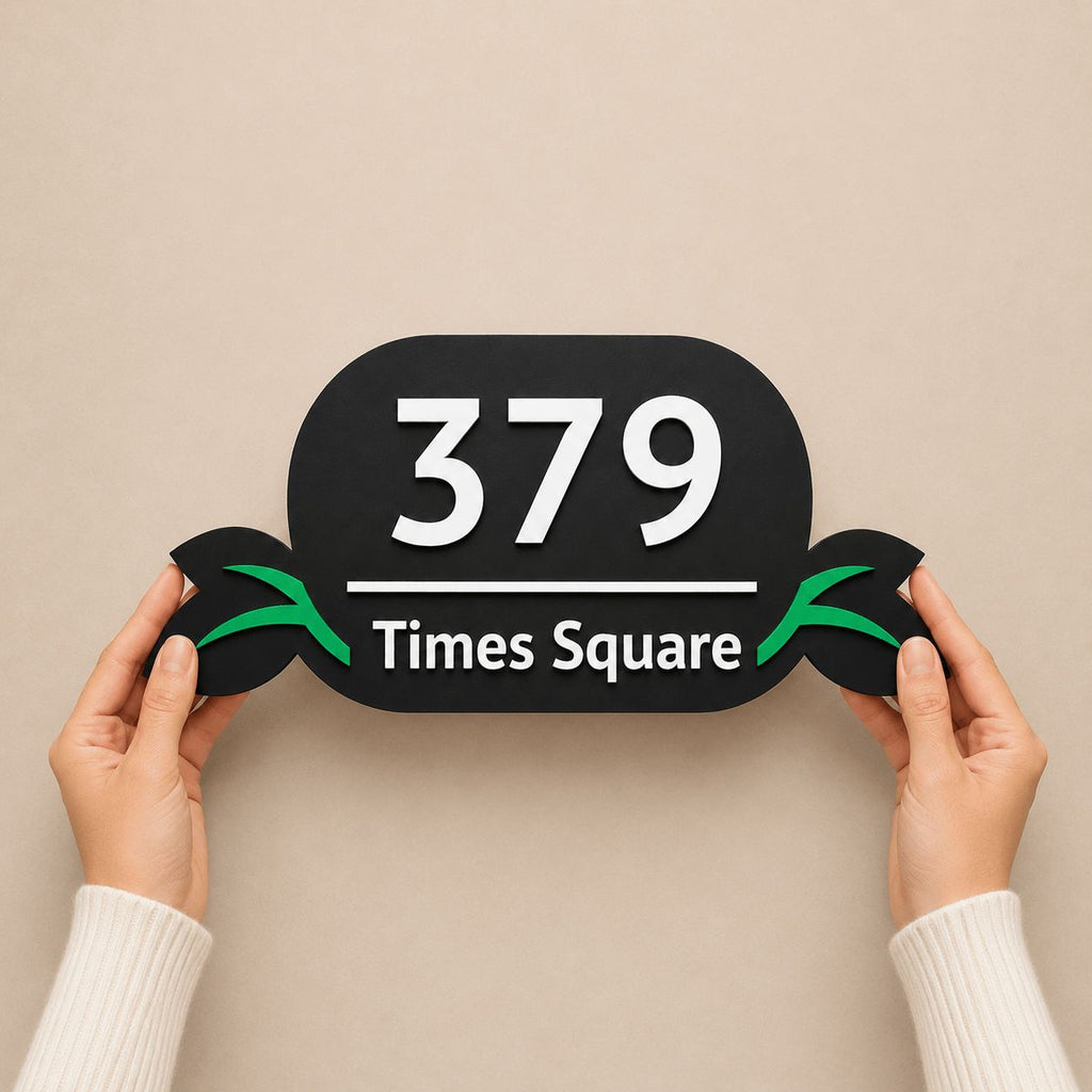 Hands holding a black acrylic number plate with embossed 3D letters and green leaf design, India