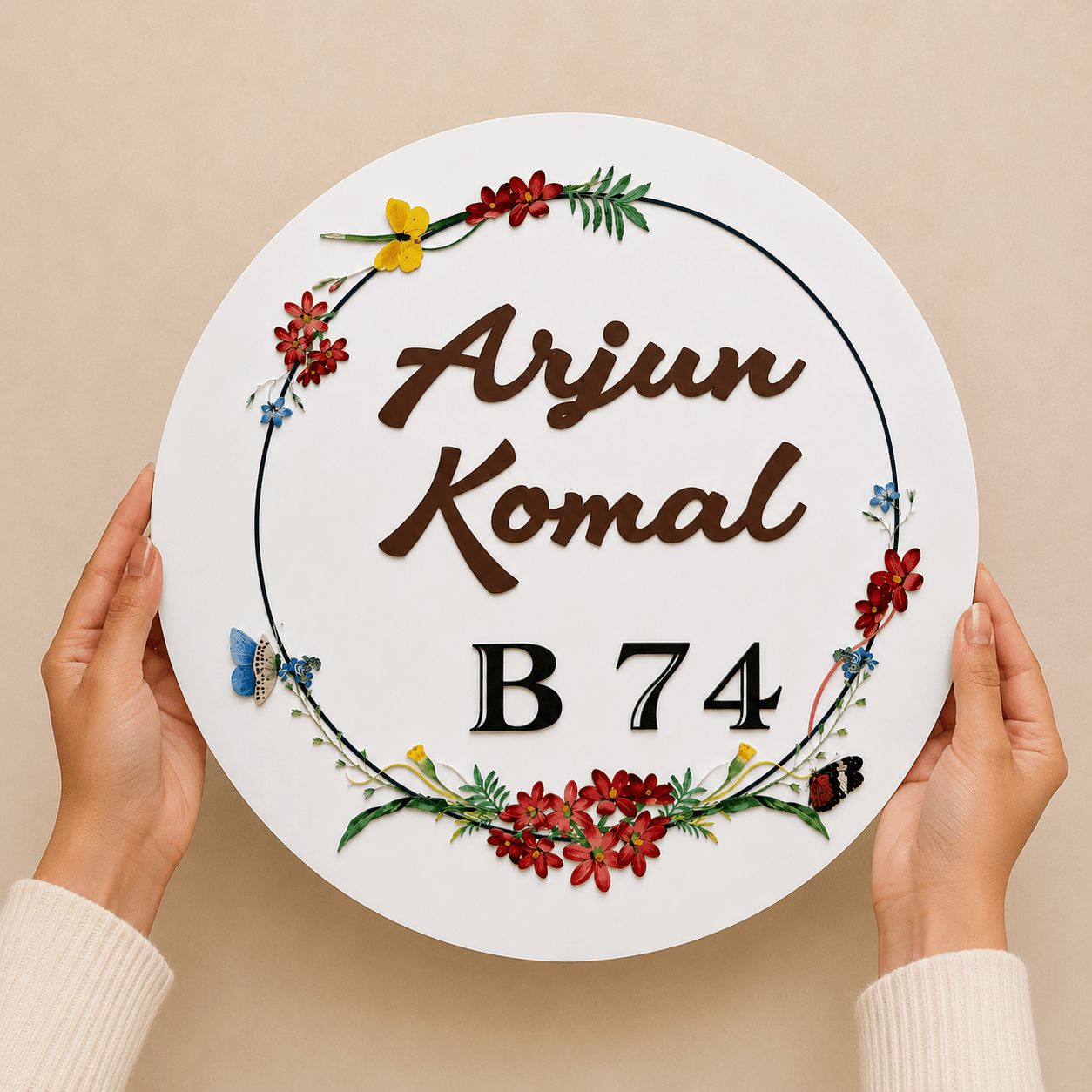 Hands holding a round acrylic name plate with wildflower floral UV print, personalised for couples