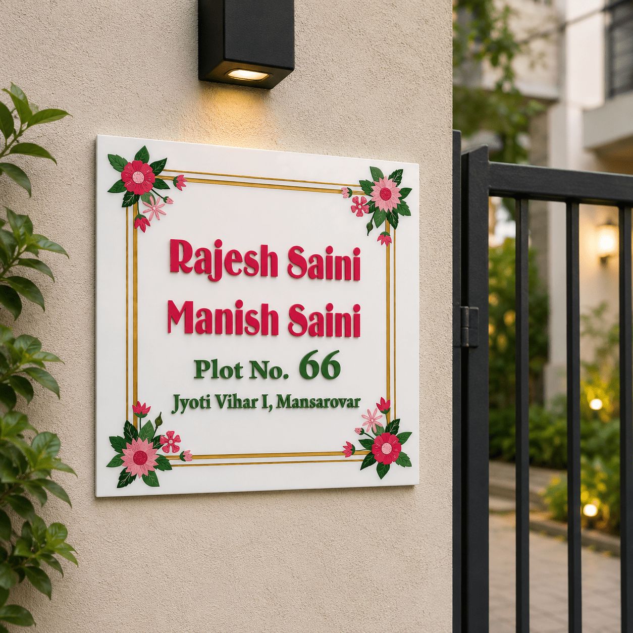 Personalised square acrylic name plate with floral design installed on house exterior wall near gate