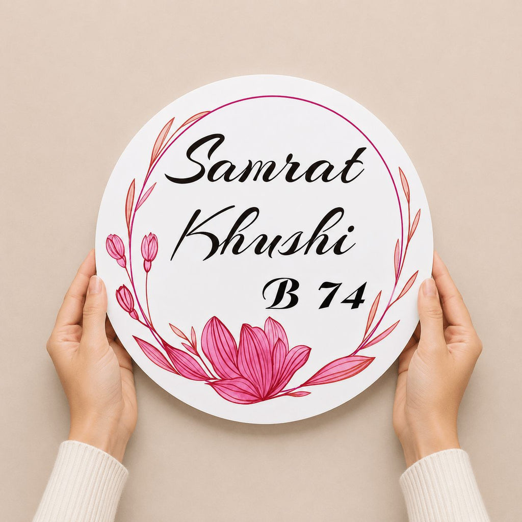 Hands holding a round white acrylic name plate with pink lotus floral UV print, made in Jaipur