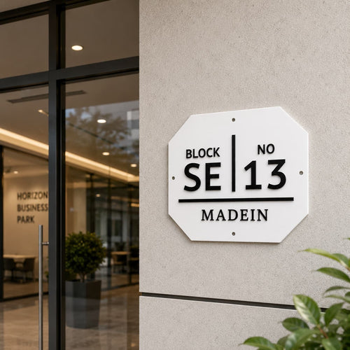 White acrylic block number name plate installed at an office entrance
