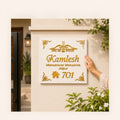 White acrylic Khatu Shyam name plate with golden mirror letters on villa entrance wall